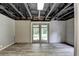 Finished basement with newly installed flooring and sliding glass doors to the outdoors providing easy access and natural light at 2864 Winder Hwy, Dacula, GA 30019