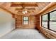 Bedroom featuring wood-paneled walls, ceiling, and bright windows at 2864 Winder Hwy, Dacula, GA 30019