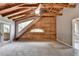 Vaulted ceiling, log wall and window make a unique design to this bedroom with gray walls at 2864 Winder Hwy, Dacula, GA 30019