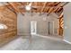 Bedroom showcasing log accent wall, vaulted ceiling, neutral gray carpet, and open bathroom at 2864 Winder Hwy, Dacula, GA 30019
