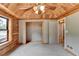 Bedroom featuring wood-paneled walls, ceiling, and a closet at 2864 Winder Hwy, Dacula, GA 30019