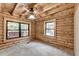 Bedroom with a wooden ceiling, wood siding, and windows with natural light at 2864 Winder Hwy, Dacula, GA 30019