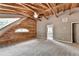 Bedroom featuring a log wall, vaulted wood ceiling, and neutral gray carpet and walls at 2864 Winder Hwy, Dacula, GA 30019