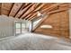Bright bedroom with vaulted ceiling, fan, log wall detail, and sliding door to deck at 2864 Winder Hwy, Dacula, GA 30019