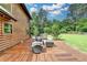 Inviting deck with stylish outdoor seating, perfect for relaxation and enjoying the tranquil wooded views at 2864 Winder Hwy, Dacula, GA 30019