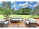 Inviting deck with stylish outdoor seating, perfect for relaxation and enjoying the tranquil wooded views at 2864 Winder Hwy, Dacula, GA 30019