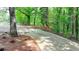 Concrete driveway leading through a wooded area with lush greenery at 2864 Winder Hwy, Dacula, GA 30019