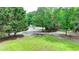 A stone fire pit in a clearing surrounded by lush trees at 2864 Winder Hwy, Dacula, GA 30019