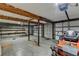 Spacious garage featuring concrete floors, ample shelving, and a large garage door, perfect for storage or workshop at 2864 Winder Hwy, Dacula, GA 30019