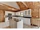 Spacious kitchen features wooden ceiling, white cabinets, and black countertops with a kitchen island at 2864 Winder Hwy, Dacula, GA 30019