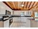 Spacious kitchen features wooden ceiling, white cabinets, black countertops and an island in the middle at 2864 Winder Hwy, Dacula, GA 30019
