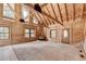 Large living room featuring vaulted ceilings, wood siding, and large windows, offering ample natural light at 2864 Winder Hwy, Dacula, GA 30019