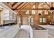 Living room with a wooden ceiling, tiled floors, fireplace, large windows, and wood siding walls at 2864 Winder Hwy, Dacula, GA 30019