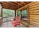 Cozy covered porch with a red porch swing overlooking the peaceful yard at 2864 Winder Hwy, Dacula, GA 30019