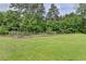 Spacious yard with lush green grass and mature trees, enhanced by a lovely fence at 2864 Winder Hwy, Dacula, GA 30019