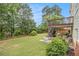 Spacious backyard with a patio, upper deck, lush green lawn and mature trees at 4045 Bonnett Creek Ln, Hoschton, GA 30548