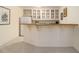 Basement bar offers cabinet storage, sink, counter seating, and a mini-refrigerator at 4045 Bonnett Creek Ln, Hoschton, GA 30548