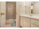 Well-lit bathroom featuring a shower-tub combo, vanity with a sink, and a neutral color palette at 4045 Bonnett Creek Ln, Hoschton, GA 30548