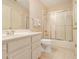 Bathroom featuring single vanity, tile floor and shower/tub combo with sliding glass door at 4045 Bonnett Creek Ln, Hoschton, GA 30548