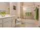 Bathroom featuring a single vanity with white cabinetry, tile floor, and shower/tub combo with sliding doors at 4045 Bonnett Creek Ln, Hoschton, GA 30548