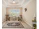 Bedroom featuring a high trey ceiling, plush carpet, three rocking chairs, and neutral paint at 4045 Bonnett Creek Ln, Hoschton, GA 30548
