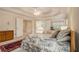 Bright primary bedroom showcasing tray ceilings, two beds, and an attached bathroom at 4045 Bonnett Creek Ln, Hoschton, GA 30548