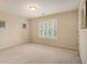 Bedroom with natural light, neutral carpet, and plantation shutters at 4045 Bonnett Creek Ln, Hoschton, GA 30548