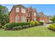 Charming brick home with manicured landscaping and a lush green lawn at 4045 Bonnett Creek Ln, Hoschton, GA 30548