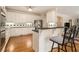 Bright kitchen with white cabinets, stainless steel appliances, and a breakfast bar with seating at 4045 Bonnett Creek Ln, Hoschton, GA 30548