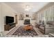 Inviting living room with built-in shelving, fireplace, comfortable seating, and natural light at 4045 Bonnett Creek Ln, Hoschton, GA 30548