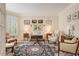 Formal living room with decorative rug and bay window at 4045 Bonnett Creek Ln, Hoschton, GA 30548