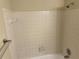 Neutral bathroom featuring white tiled walls, shower head, and towel bar at 1165 Oaks Pl, Stone Mountain, GA 30083