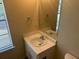 Bathroom featuring a single sink, mirror, and natural light from a window at 1165 Oaks Pl, Stone Mountain, GA 30083