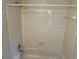 A clean white tiled shower and bathtub combination at 1165 Oaks Pl, Stone Mountain, GA 30083