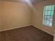 Bedroom featuring carpeted floors, neutral paint, and a window at 1165 Oaks Pl, Stone Mountain, GA 30083