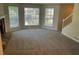 Spacious living room featuring multiple windows, neutral paint, and a fireplace at 1165 Oaks Pl, Stone Mountain, GA 30083