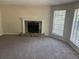 Inviting living room featuring a stone fireplace, neutral paint, and large windows offering natural light at 1165 Oaks Pl, Stone Mountain, GA 30083