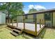 View of the backyard deck with wood railing, and a small shed at 1824 Atherton Dr, Decatur, GA 30035