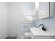 A modern bathroom featuring a tiled shower and updated vanity with storage at 1824 Atherton Dr, Decatur, GA 30035