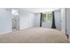 A bright, carpeted bedroom featuring a ensuite bathroom, closet, and large window with backyard views at 1824 Atherton Dr, Decatur, GA 30035
