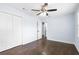Light-filled bedroom with hardwood floors, white closets and doors, blue walls, and a ceiling fan at 1824 Atherton Dr, Decatur, GA 30035