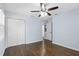Bedroom featuring hardwood floors, blue walls, a ceiling fan, closet, and entry door at 1824 Atherton Dr, Decatur, GA 30035