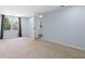 A spacious bedroom featuring neutral carpet, light blue walls and a large window at 1824 Atherton Dr, Decatur, GA 30035