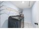 A modern laundry room with gray front load machines, shelving and marble look floors at 1824 Atherton Dr, Decatur, GA 30035