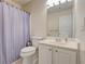 Neutral bathroom with white vanity and toilet, paired with a shower featuring a striped curtain at 2707 Mariner Way, Villa Rica, GA 30180