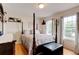 Bedroom with four poster bed, wood floors, and natural light from two windows at 2707 Mariner Way, Villa Rica, GA 30180