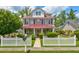 Charming two-story home with a white picket fence and manicured landscaping at 2707 Mariner Way, Villa Rica, GA 30180