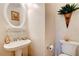 Classic powder room with pedestal sink and decorative mirror at 2707 Mariner Way, Villa Rica, GA 30180