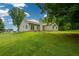 Green backyard with a gentle slope, showcasing the home's exterior and well-maintained lawn at 3217 New Rutledge Nw Rd, Kennesaw, GA 30152