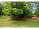 Spacious backyard featuring a lush lawn and privacy fence, providing a serene outdoor retreat at 3217 New Rutledge Nw Rd, Kennesaw, GA 30152